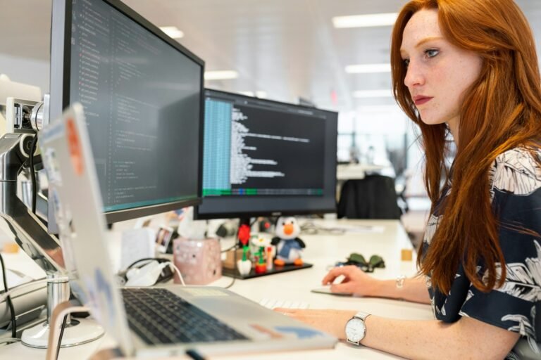 Engineer monitoring systems on screens
