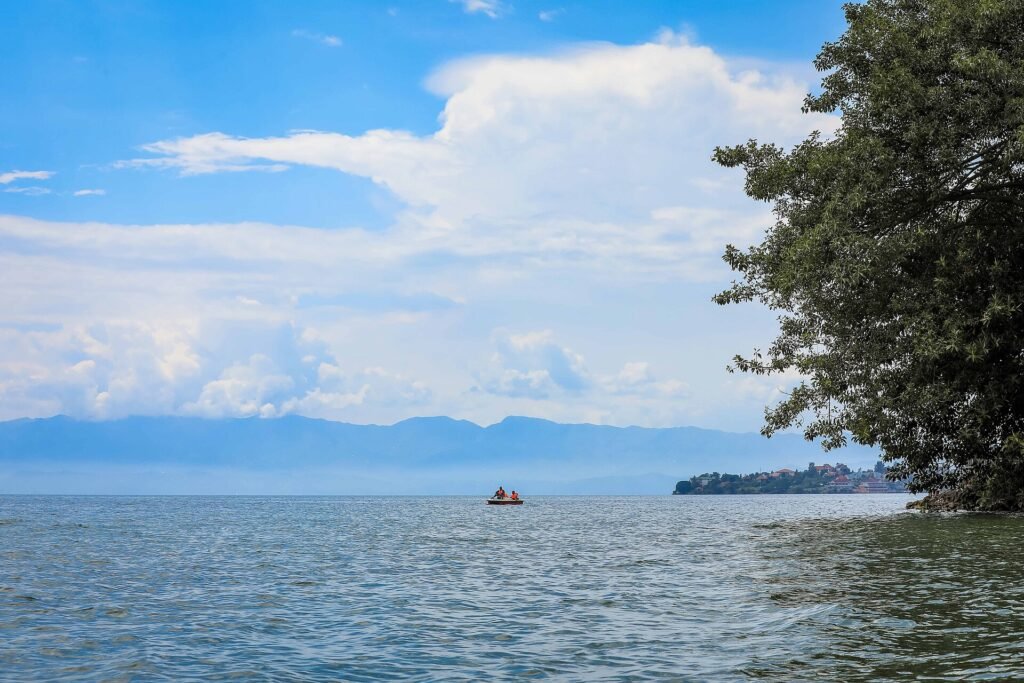Men ride a boat in Kivu Lake in Rubavu District, Rwanda. Emmanuel Kwizera